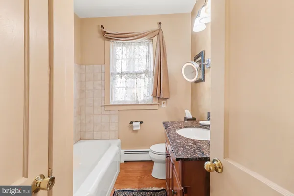 a bathroom with a sink toilet and tub