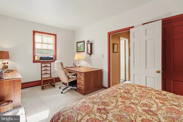 a bedroom with a workspace