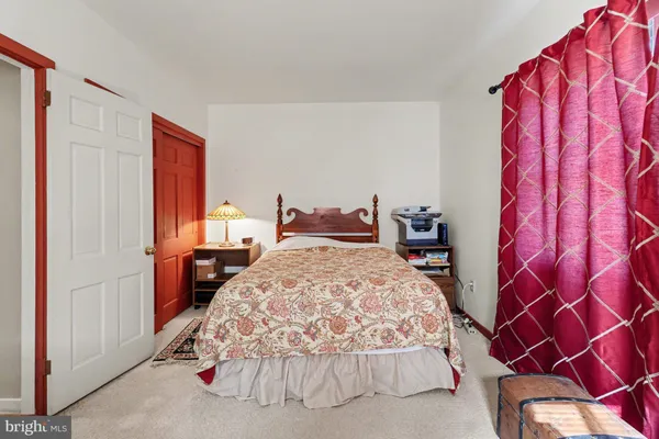 a bedroom with a bed and a lamp