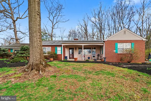 a front view of a house with yard porch and furniture