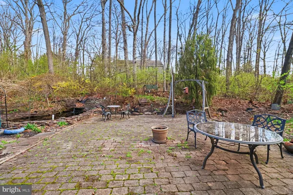 a view of a backyard with plants and sitting area