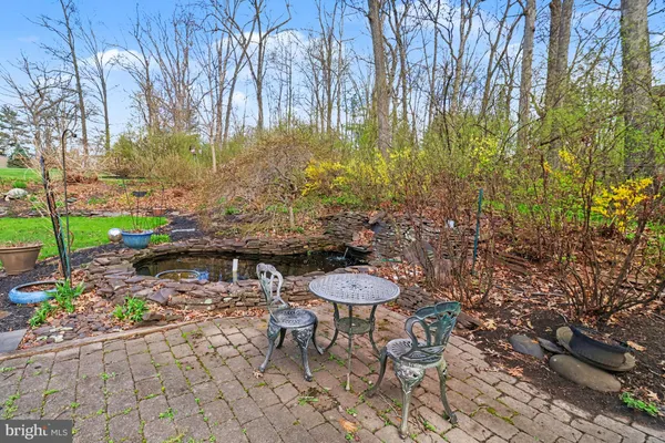 a view of a chairs and table in backyard