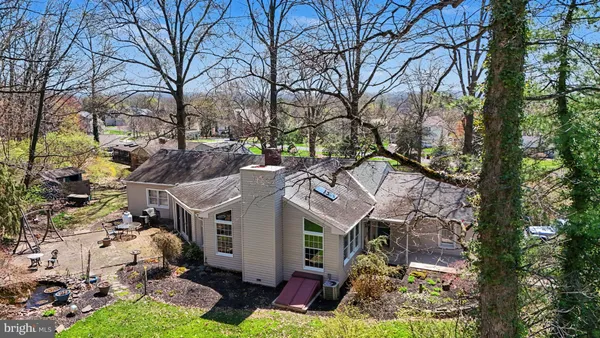 a aerial view of a house with a yard and potted plants