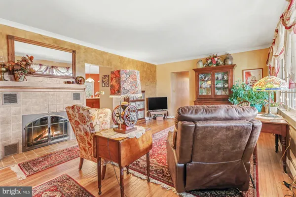 a dining room with furniture a flat screen tv and a floor to ceiling window