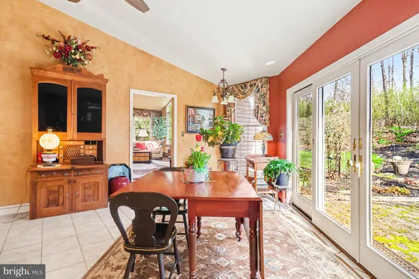 a dining room with furniture a chandelier and wooden floor