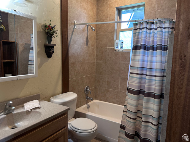 1940 East Shore Road St. Charles, ID 83272 - Photo 33 of 64 Full bath with a textured wall, vanity, and shower / bath combo with shower curtain