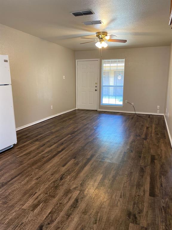 705 Miracle Lane, Unit A Cleburne, TX 76033 - Photo 6 of 7 wooden floor in an empty room with a window