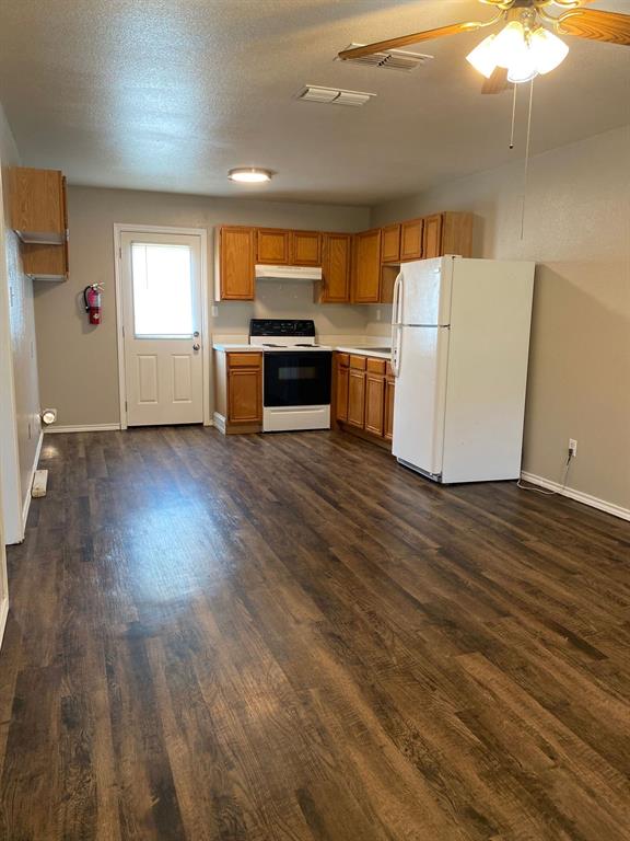 705 Miracle Lane, Unit A Cleburne, TX 76033 - Photo 7 of 7 a view of a kitchen with wooden floor and electronic appliances