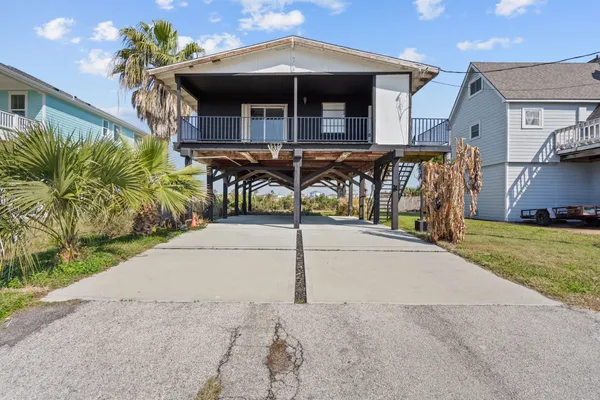 a view of a house with wooden fence