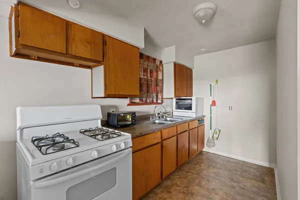 a kitchen with a stove a sink and a refrigerator