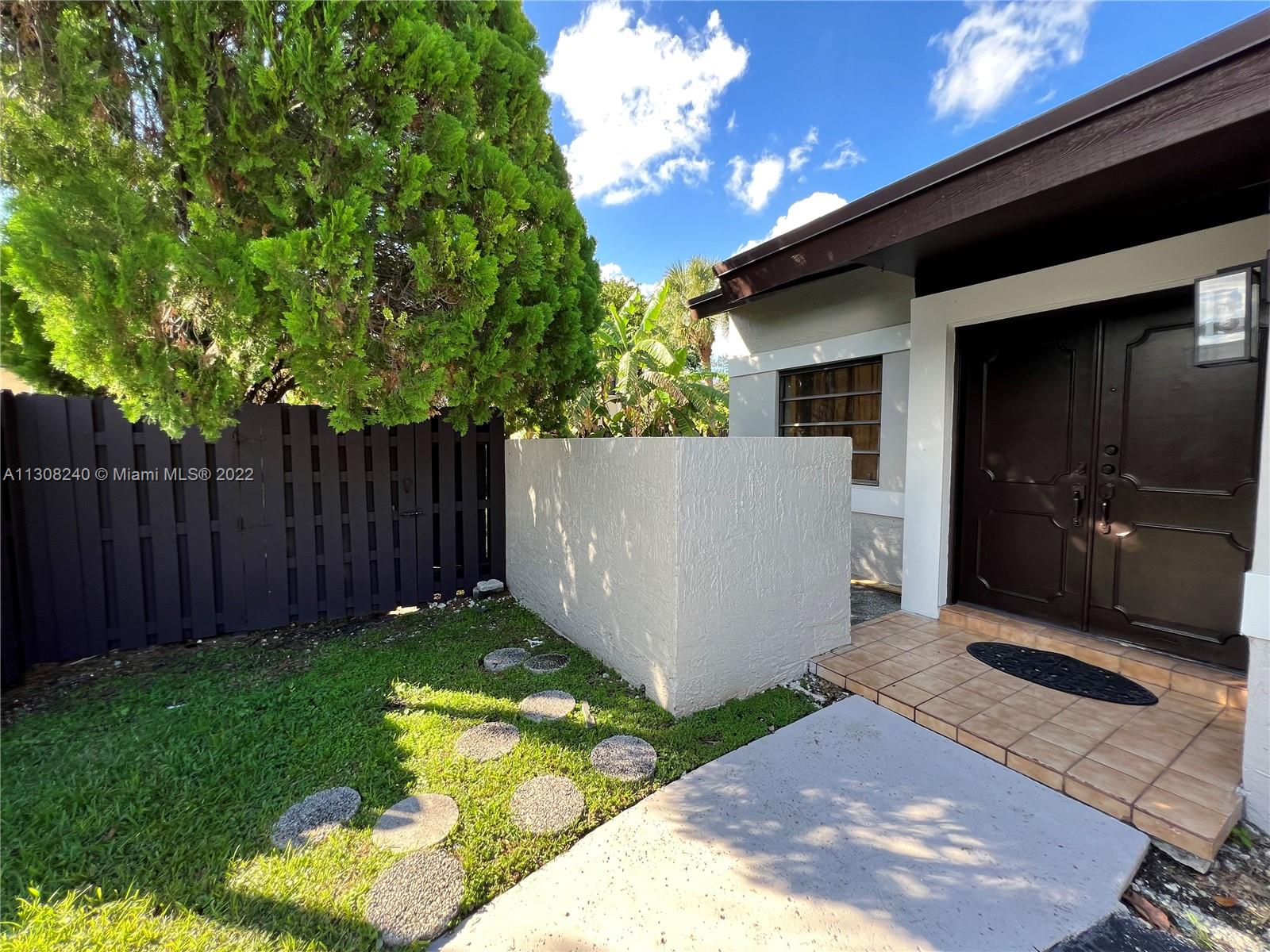 a view of backyard with tub and trees