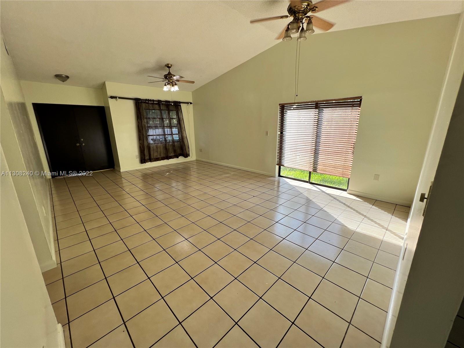 9630 Southwest 152nd Avenue, Unit 34 Miami, FL 33196 - Photo 3 of 13 a view of an empty room and a bathroom