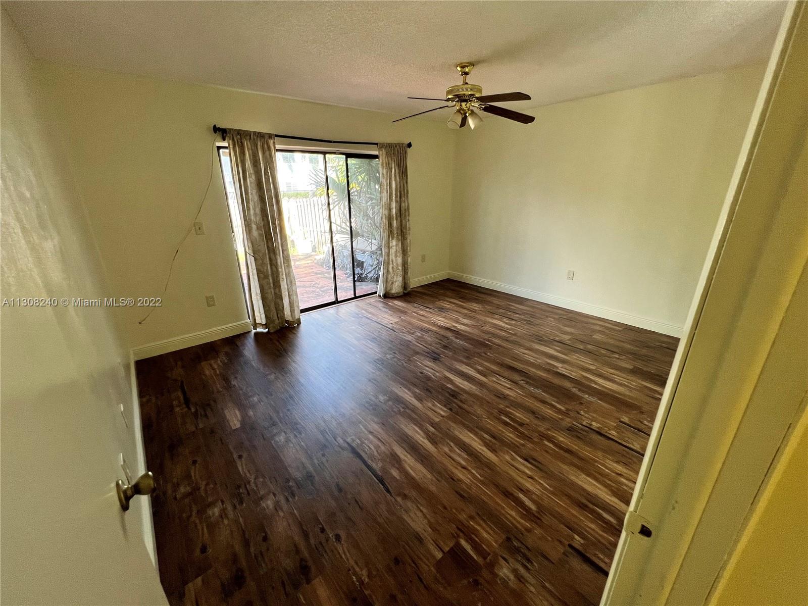 9630 Southwest 152nd Avenue, Unit 34 Miami, FL 33196 - Photo 5 of 13 a view of a room with wooden floor and a window