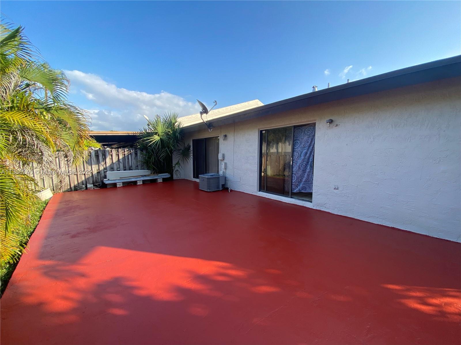 9630 Southwest 152nd Avenue, Unit 34 Miami, FL 33196 - Photo 10 of 13 a backyard of a house with table and chairs