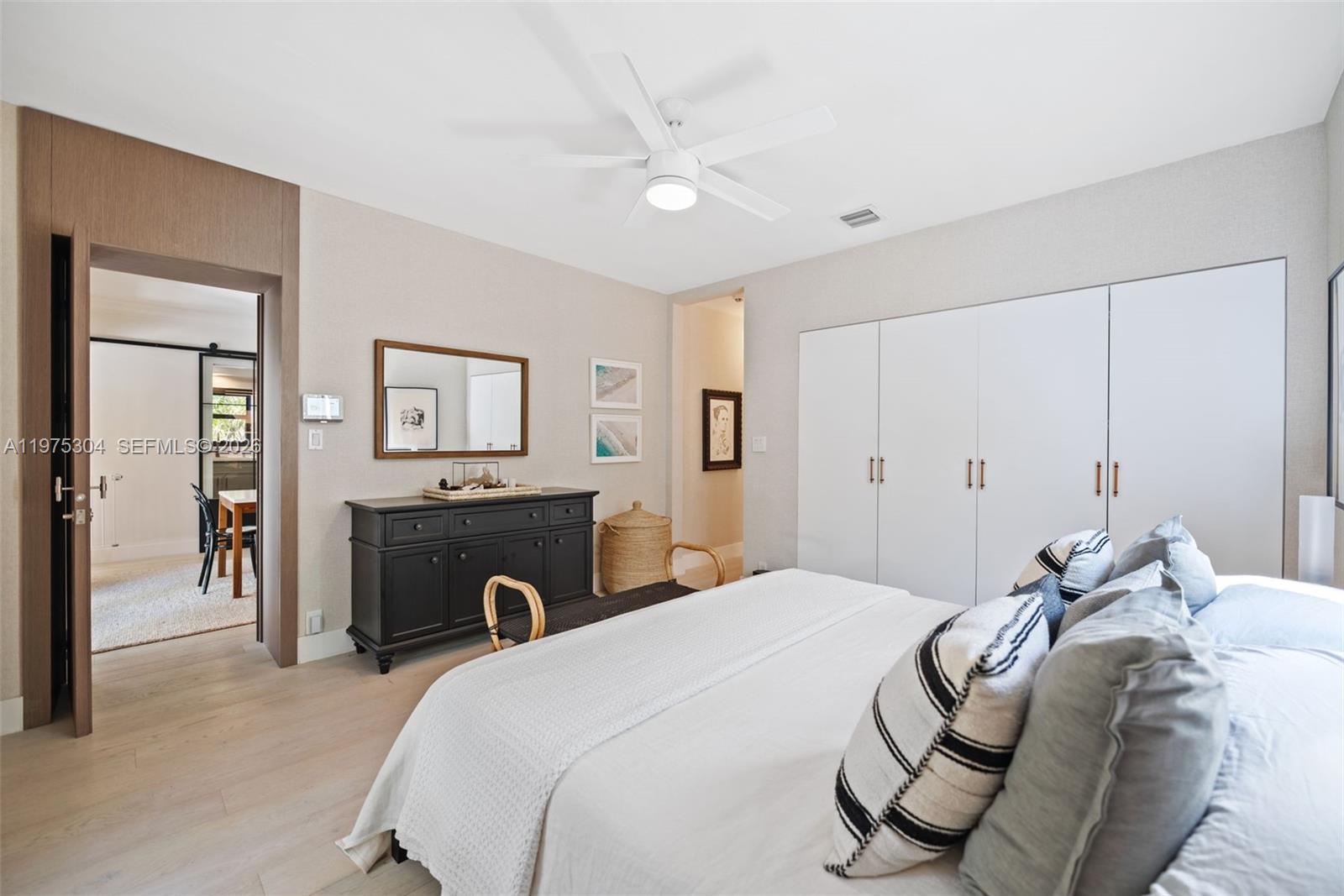 740 Northeast 76th Street Miami, FL 33138 - Photo 25 of 43 a bedroom with a bed and a chandelier