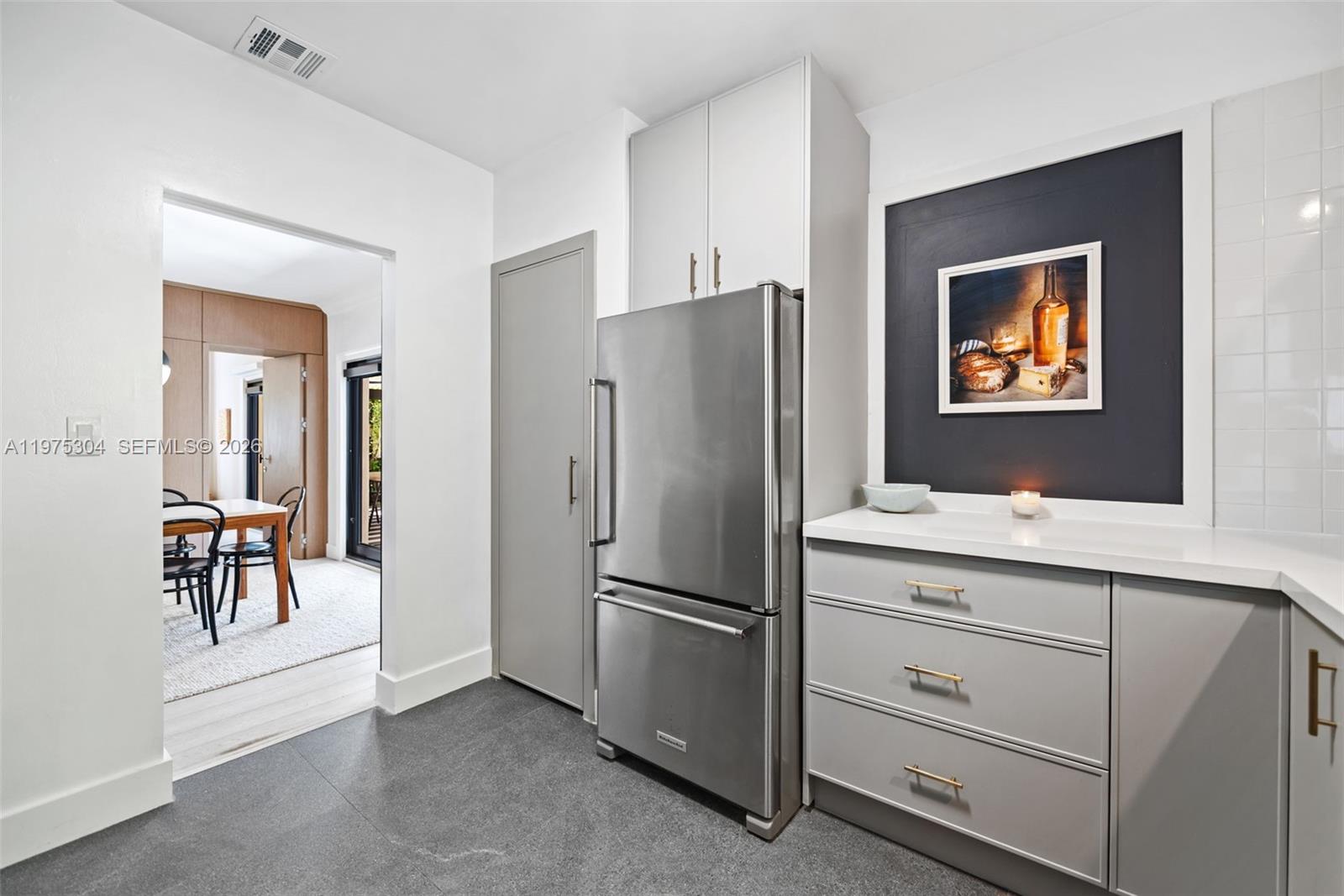 740 Northeast 76th Street Miami, FL 33138 - Photo 28 of 43 a kitchen with cabinets and stainless steel appliances