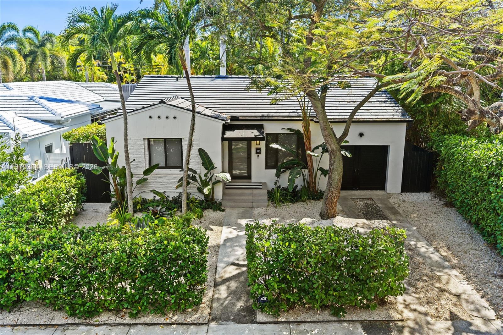740 Northeast 76th Street Miami, FL 33138 - Photo 3 of 43 front view of house with a small yard