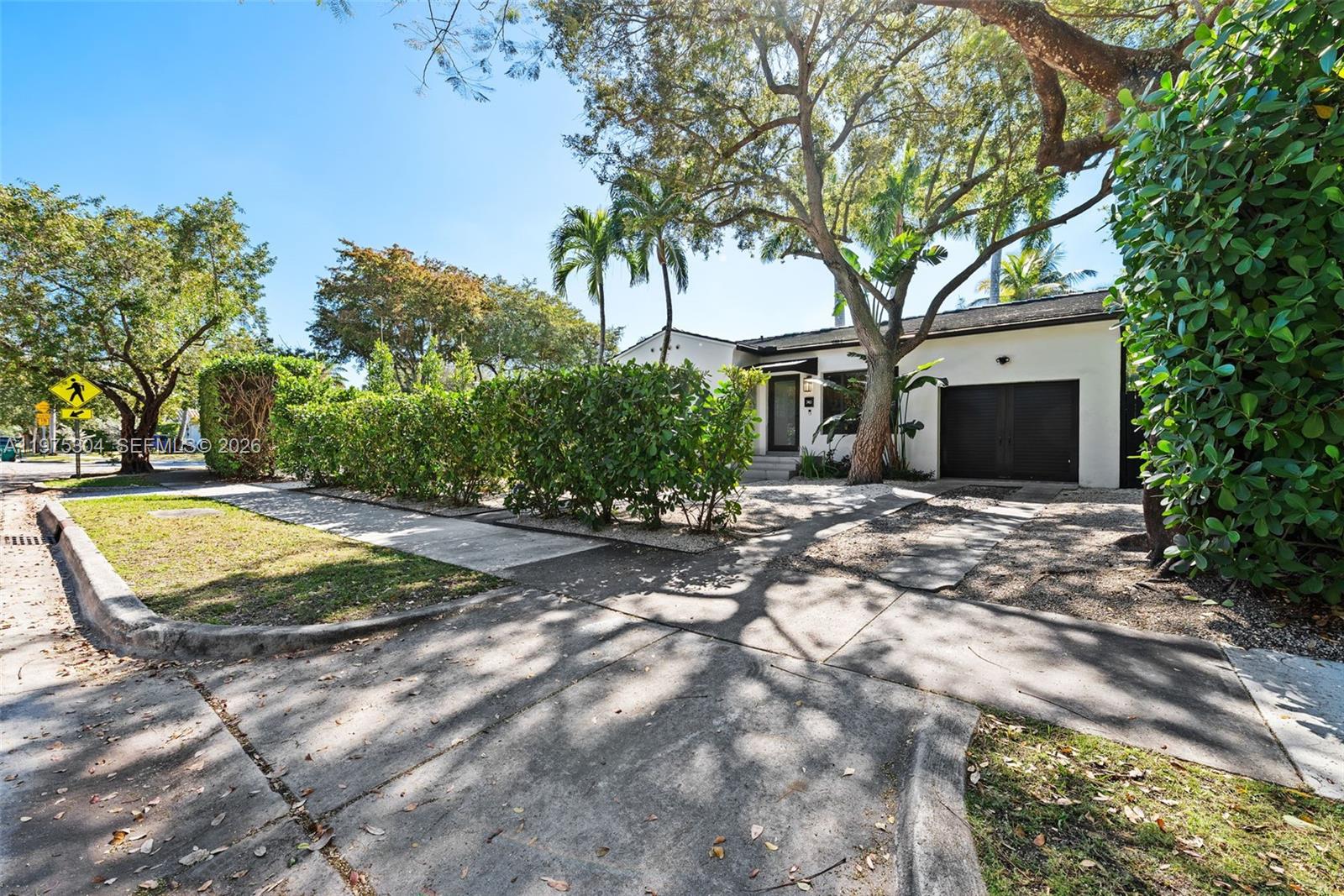 740 Northeast 76th Street Miami, FL 33138 - Photo 31 of 43 a view of a house with a yard