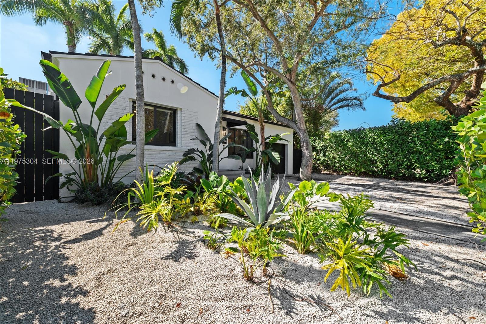 740 Northeast 76th Street Miami, FL 33138 - Photo 32 of 43 a front view of a house with a big yard