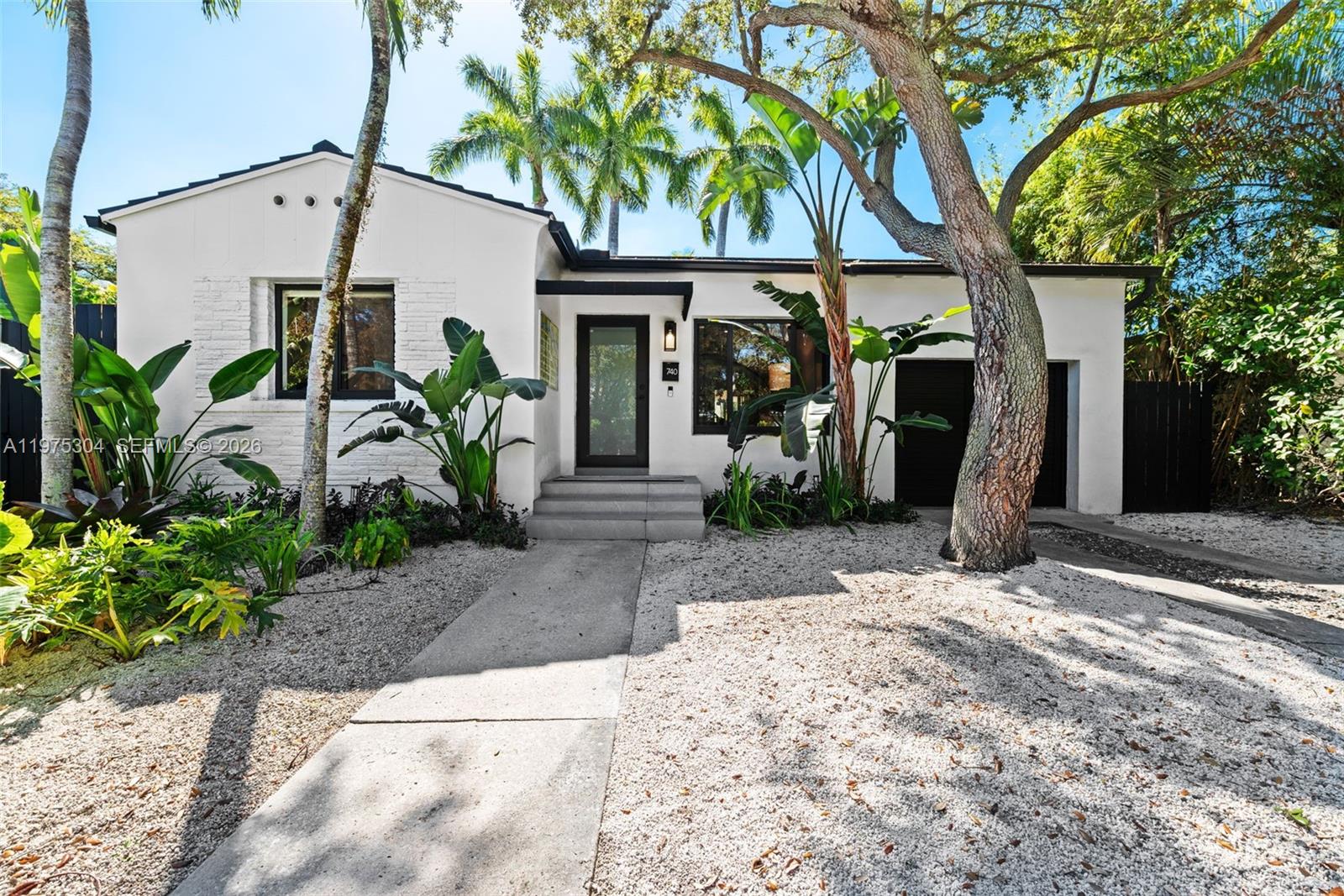 740 Northeast 76th Street Miami, FL 33138 - Photo 33 of 43 a front view of a house with garden