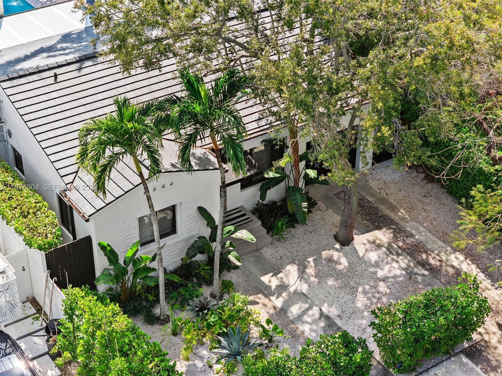 740 Northeast 76th Street Miami, FL 33138 - Photo 34 of 43 a backyard of a house with lots of green space