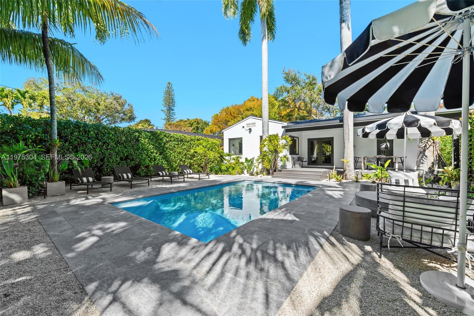 740 Northeast 76th Street Miami, FL 33138 - Photo 4 of 43 a view of a swimming pool with a patio