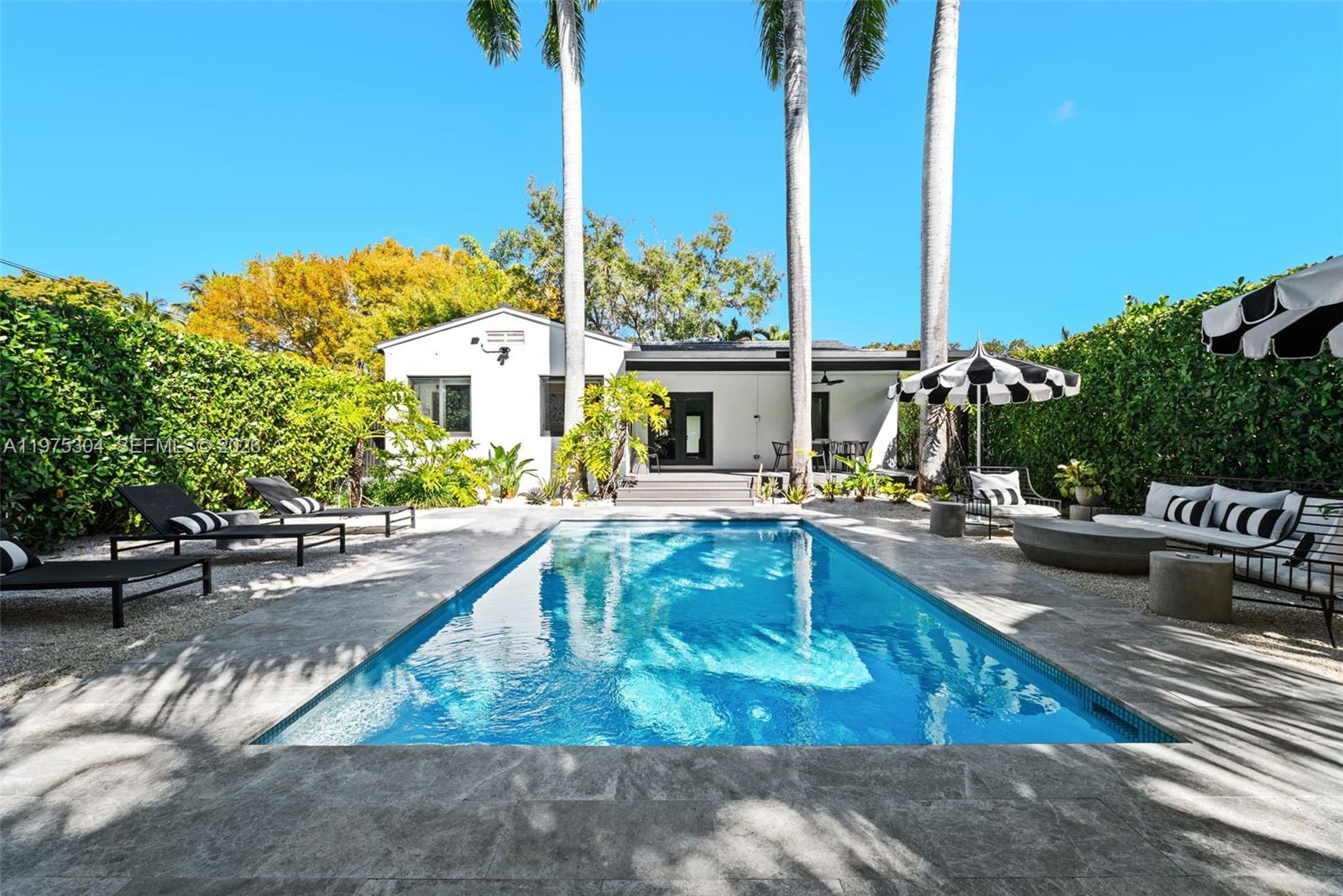740 Northeast 76th Street Miami, FL 33138 - Photo 5 of 43 a view of a swimming pool with a patio