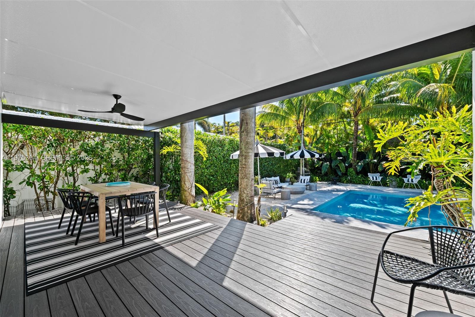 740 Northeast 76th Street Miami, FL 33138 - Photo 6 of 43 a living room with large trees and furniture