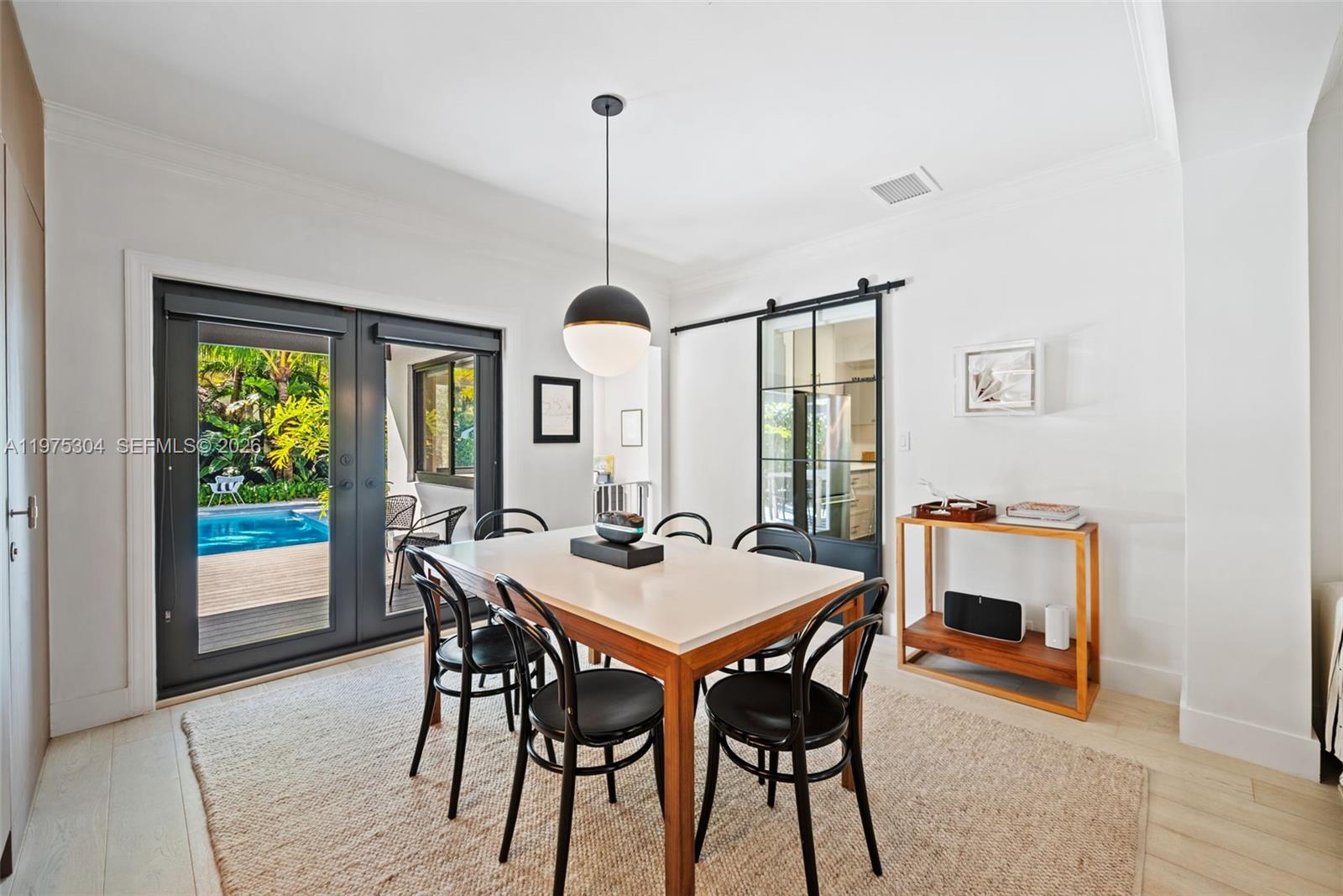 740 Northeast 76th Street Miami, FL 33138 - Photo 8 of 43 a view of a dining room with furniture window and wooden floor