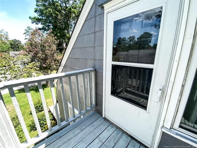 a view of balcony with wooden floor