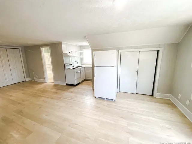 a view of a kitchen with refrigerator and washer