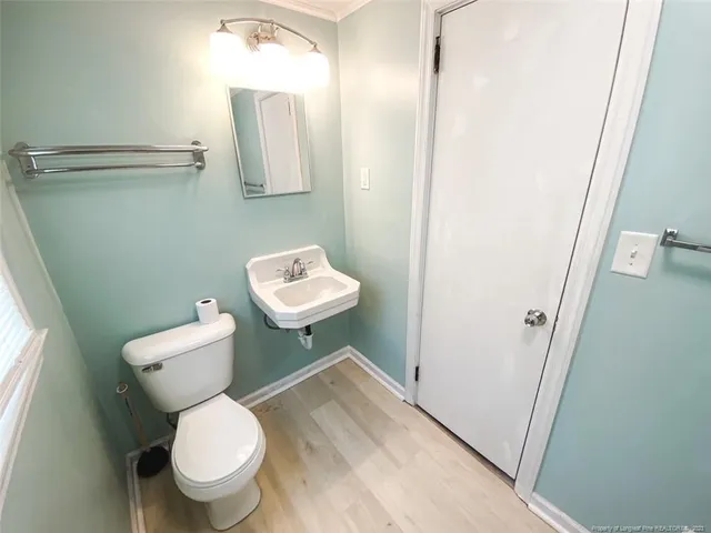 a white toilet sitting next to a bathroom sink and vanity