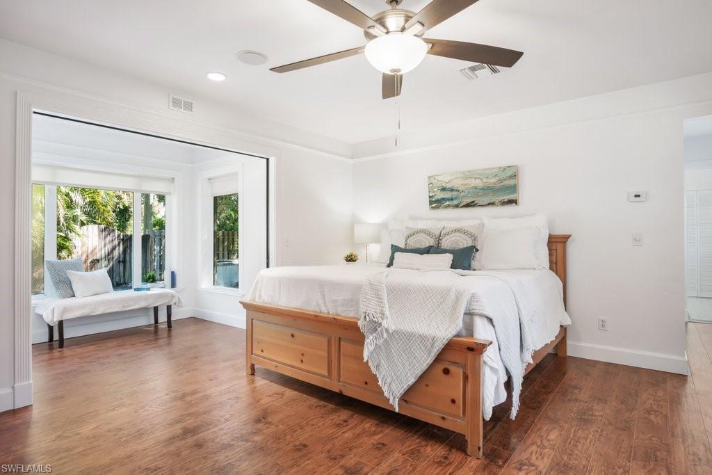 2300 North Road Naples, FL 34104 - Photo 11 of 20 a bedroom with a large bed and a chandelier fan