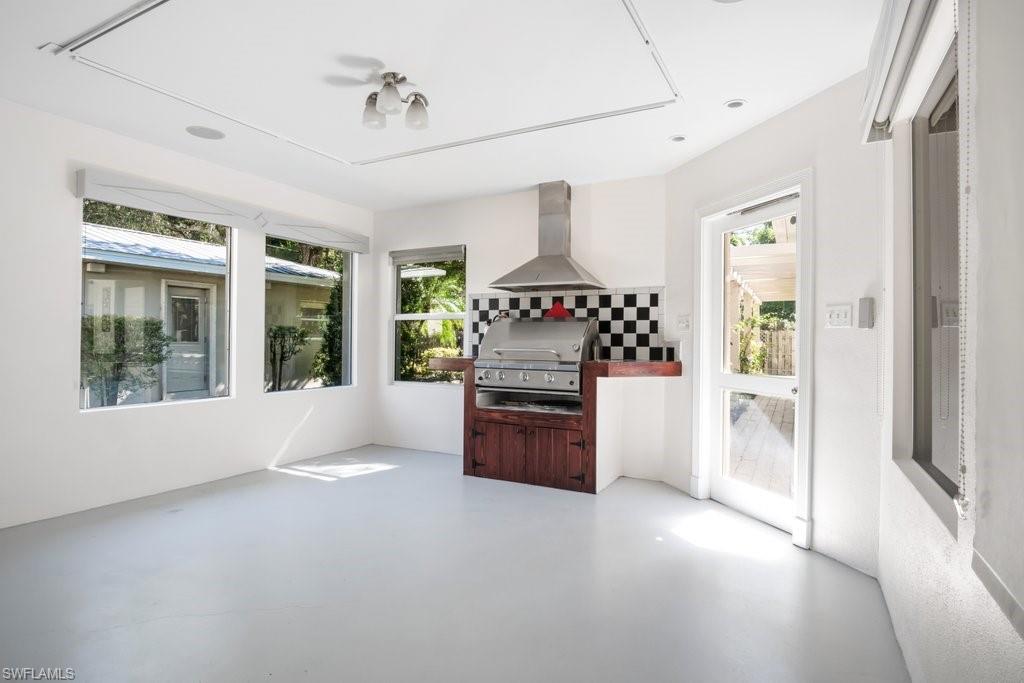 2300 North Road Naples, FL 34104 - Photo 16 of 20 a kitchen with stainless steel appliances granite countertop a stove and a refrigerator