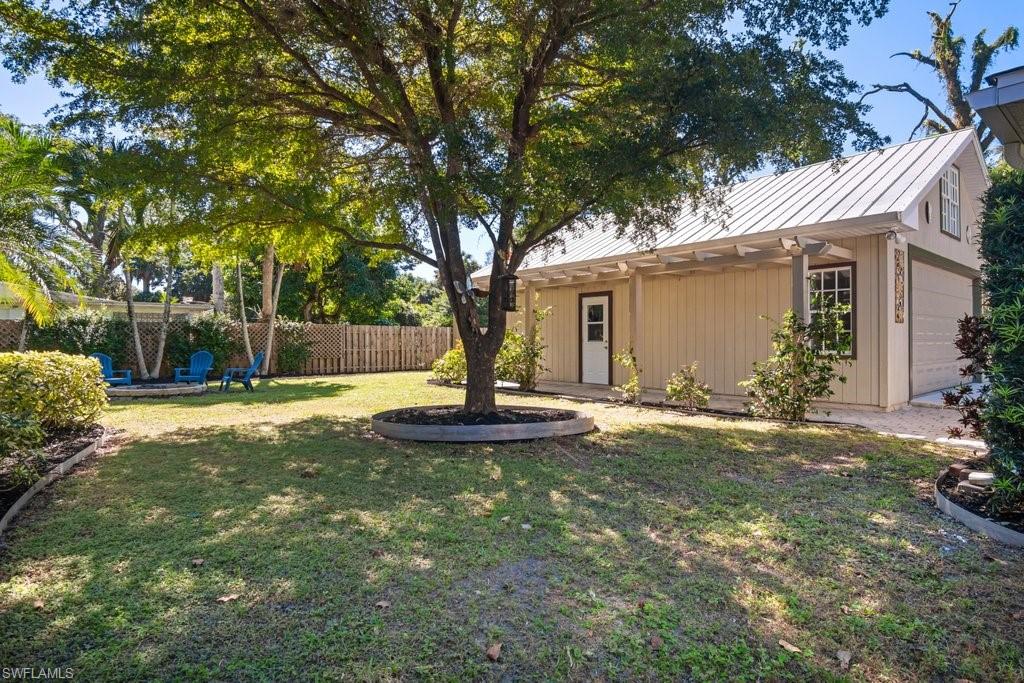 2300 North Road Naples, FL 34104 - Photo 17 of 20 a view of a house with backyard and tree