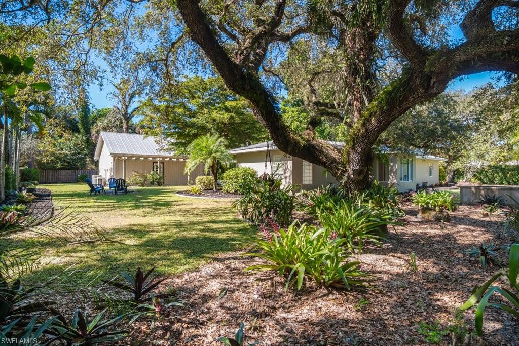 2300 North Road Naples, FL 34104 - Photo 18 of 20 a house that has a tree in front of it