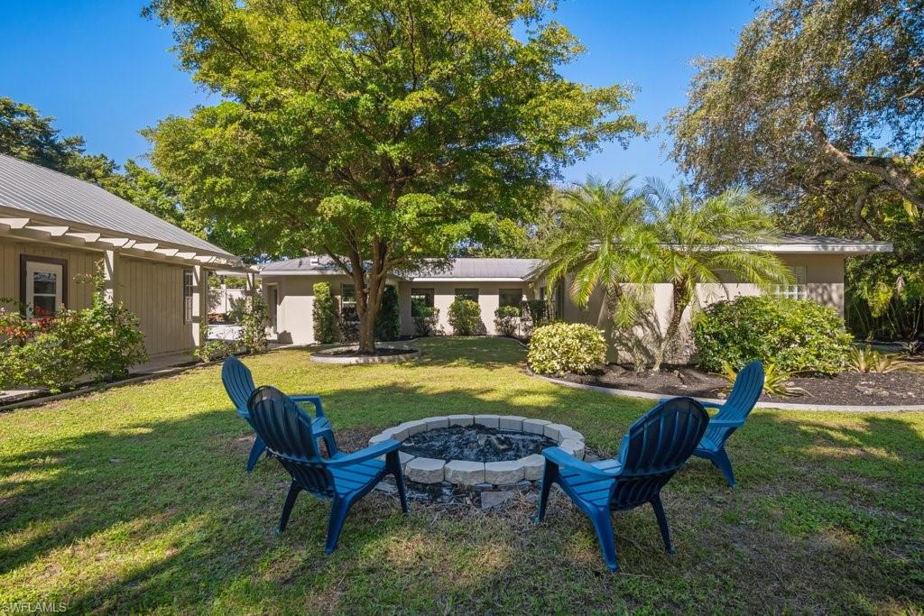 2300 North Road Naples, FL 34104 - Photo 19 of 20 a swimming pool with outdoor seating and yard