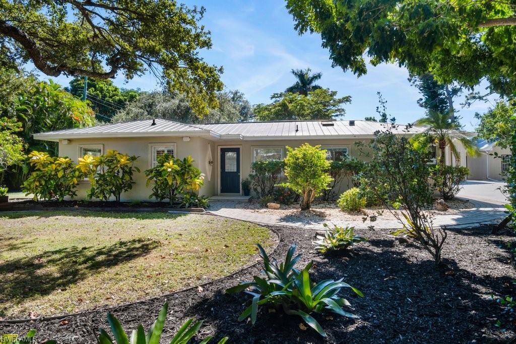 2300 North Road Naples, FL 34104 - Photo 3 of 20 a view of a backyard with plants and large trees