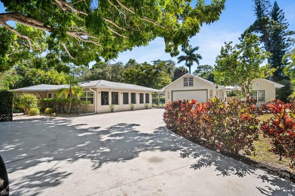 2300 North Road Naples, FL 34104 - Photo 4 of 20 a front view of a house with a garden