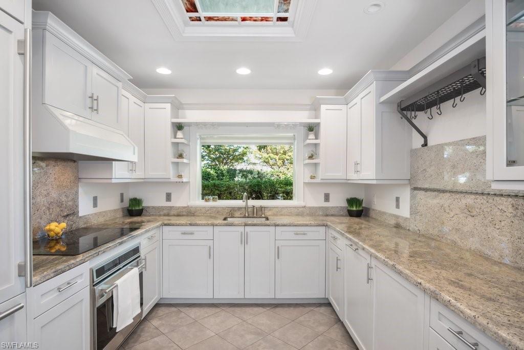 2300 North Road Naples, FL 34104 - Photo 10 of 20 a kitchen with white cabinets appliances a sink and a window