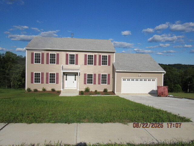 31 Warm Earth Road Naugatuck, CT 06770 - Photo 2 of 36 a front view of a house with a garden and yard