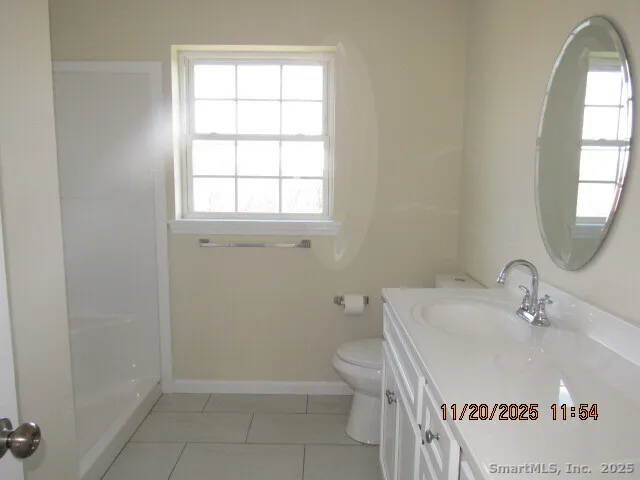 a bathroom with a sink toilet and window