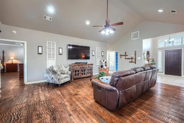a living room with furniture a dining table and a potted plant