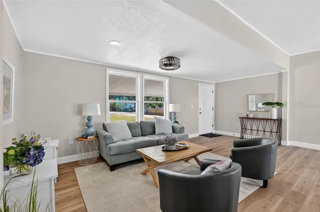 a living room with furniture and kitchen view