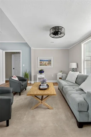 a dining room with stainless steel appliances granite countertop a dining table chairs stove and white cabinets