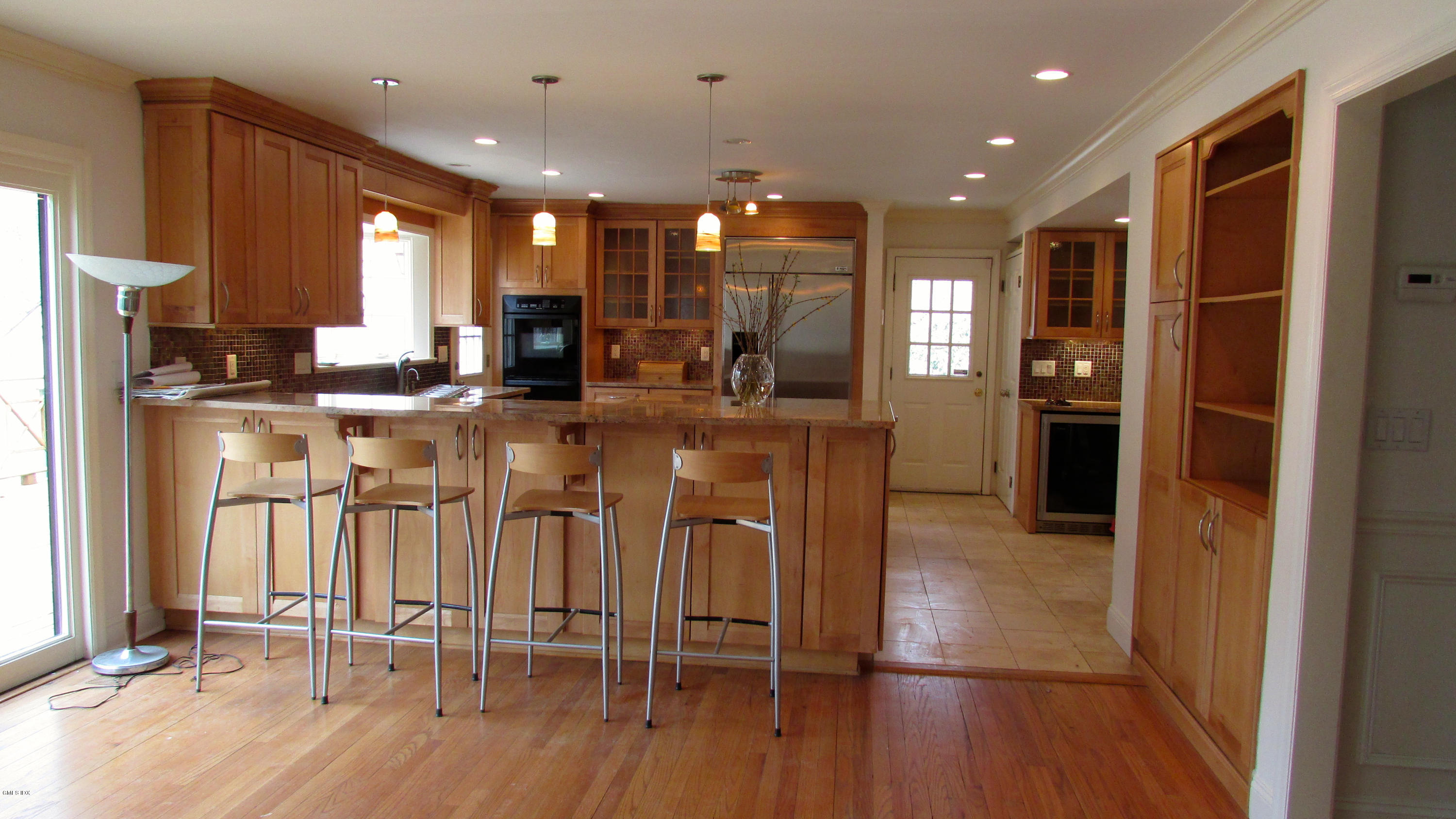 100 North Old Stone Bridge Road Cos Cob, CT 06807 - Photo 3 of 16 a view of a kitchen with kitchen island granite countertop wooden floor and stainless steel appliances