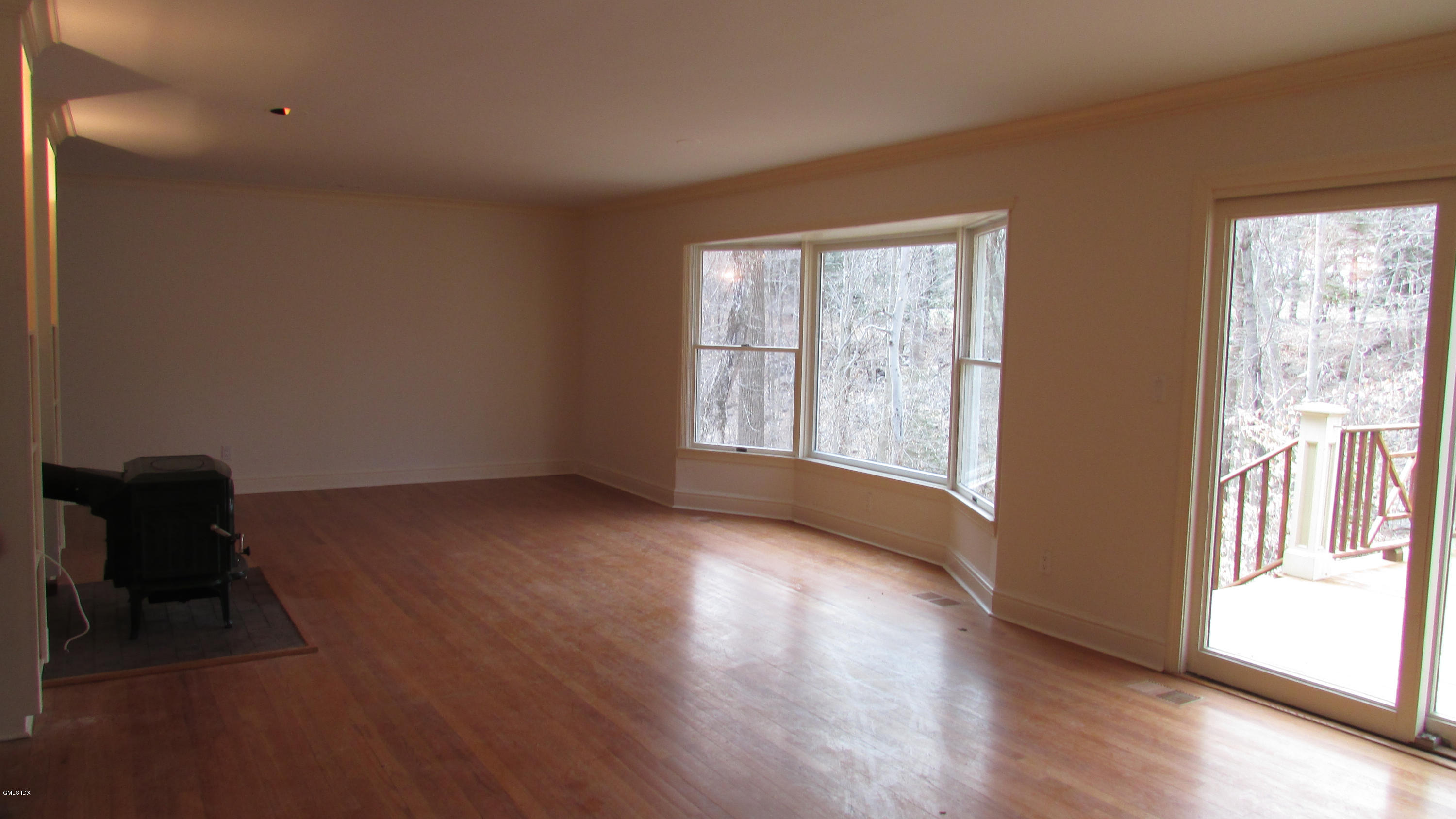100 North Old Stone Bridge Road Cos Cob, CT 06807 - Photo 5 of 16 a view of an empty room with wooden floor and a window