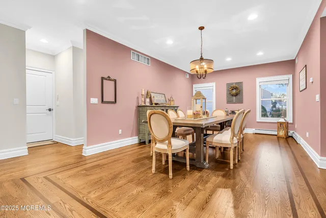 a dining room with furniture a chandelier and wooden floor