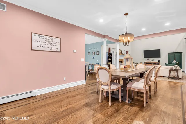 a dining room with furniture and wooden floor