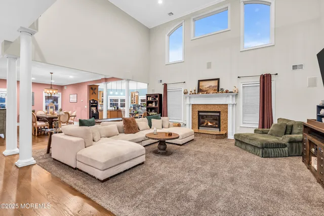 a living room filled with furniture hardwood floor and a chandelier
